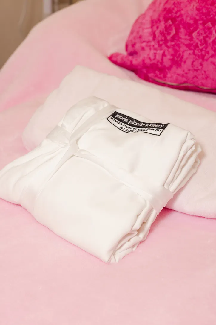 A folded Poris Plastic Surgery robe