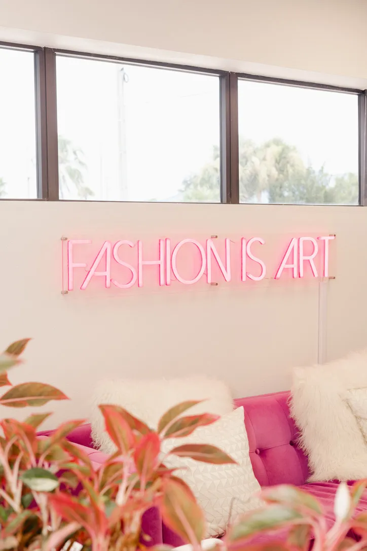 The “Fashion Is Art” neon sign in the waiting room